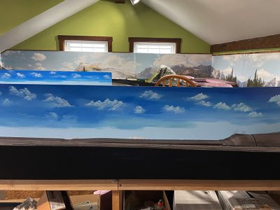 David Sloan painting sky and clouds on the inner scenery backdrop